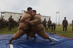 Lance Cpl. Marcus G. Merritt, left, and Lance Cpl. Luke Copeland participate in a sumo wrestling competition as part of the Shanghai Cup competition Nov. 10 aboard Camp Schwab, Okinawa, Japan. The goal of the competition was to knock the opponent out of the circle to win points for their teams. The match is three rounds long. Merritt is a rifleman and Copeland is a machine gunner with 2nd Battalion, 3rd Marine Regiment; currently assigned to 4th Marine Regiment, 3rd Marine Division, III Marine Expeditionary Force under the unit deployment program. 