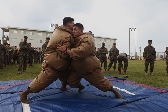 Lance Cpl. Marcus G. Merritt, left, and Lance Cpl. Luke Copeland participate in a sumo wrestling competition as part of the Shanghai Cup competition Nov. 10 aboard Camp Schwab, Okinawa, Japan. The goal of the competition was to knock the opponent out of the circle to win points for their teams. The match is three rounds long. Merritt is a rifleman and Copeland is a machine gunner with 2nd Battalion, 3rd Marine Regiment; currently assigned to 4th Marine Regiment, 3rd Marine Division, III Marine Expeditionary Force under the unit deployment program. 