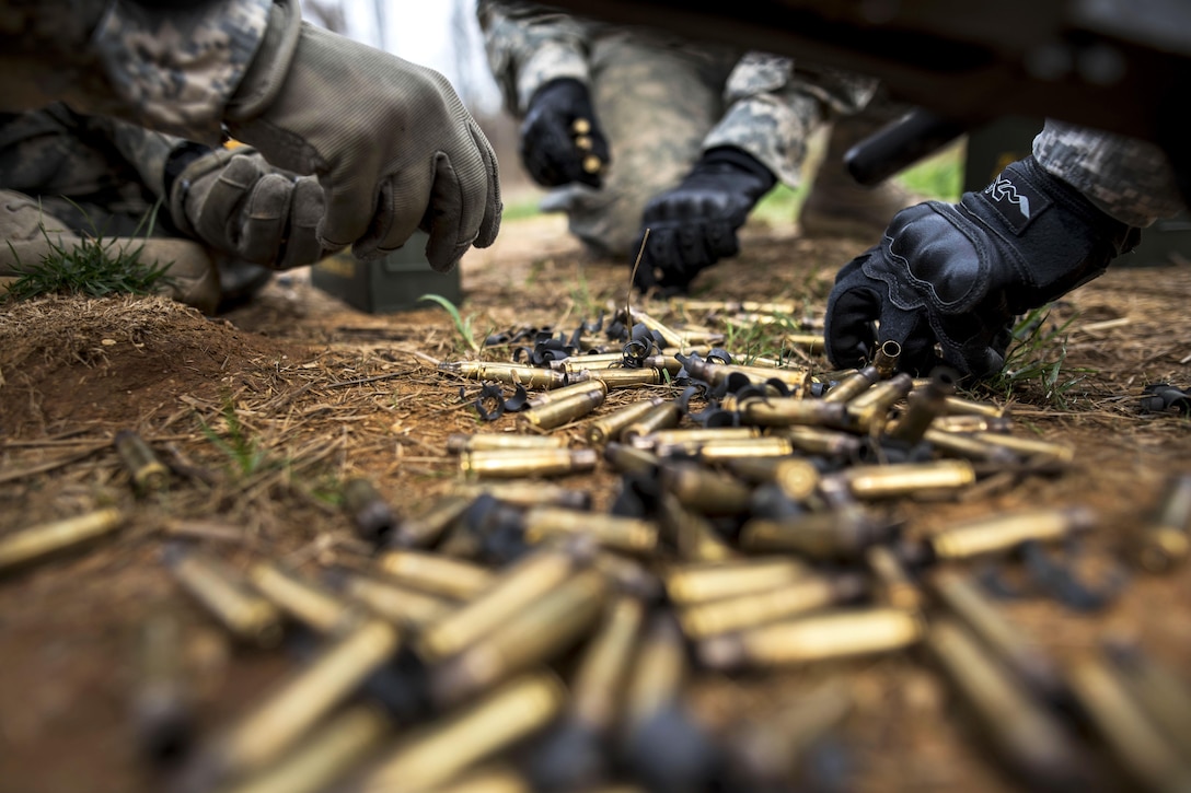 Soldiers pick up brass 7.62 mm shell casings after a qualification range event on Camp Atterbury, Ind., Nov. 6, 2015. U.S. Army photo by Master Sgt. Michel Sauret