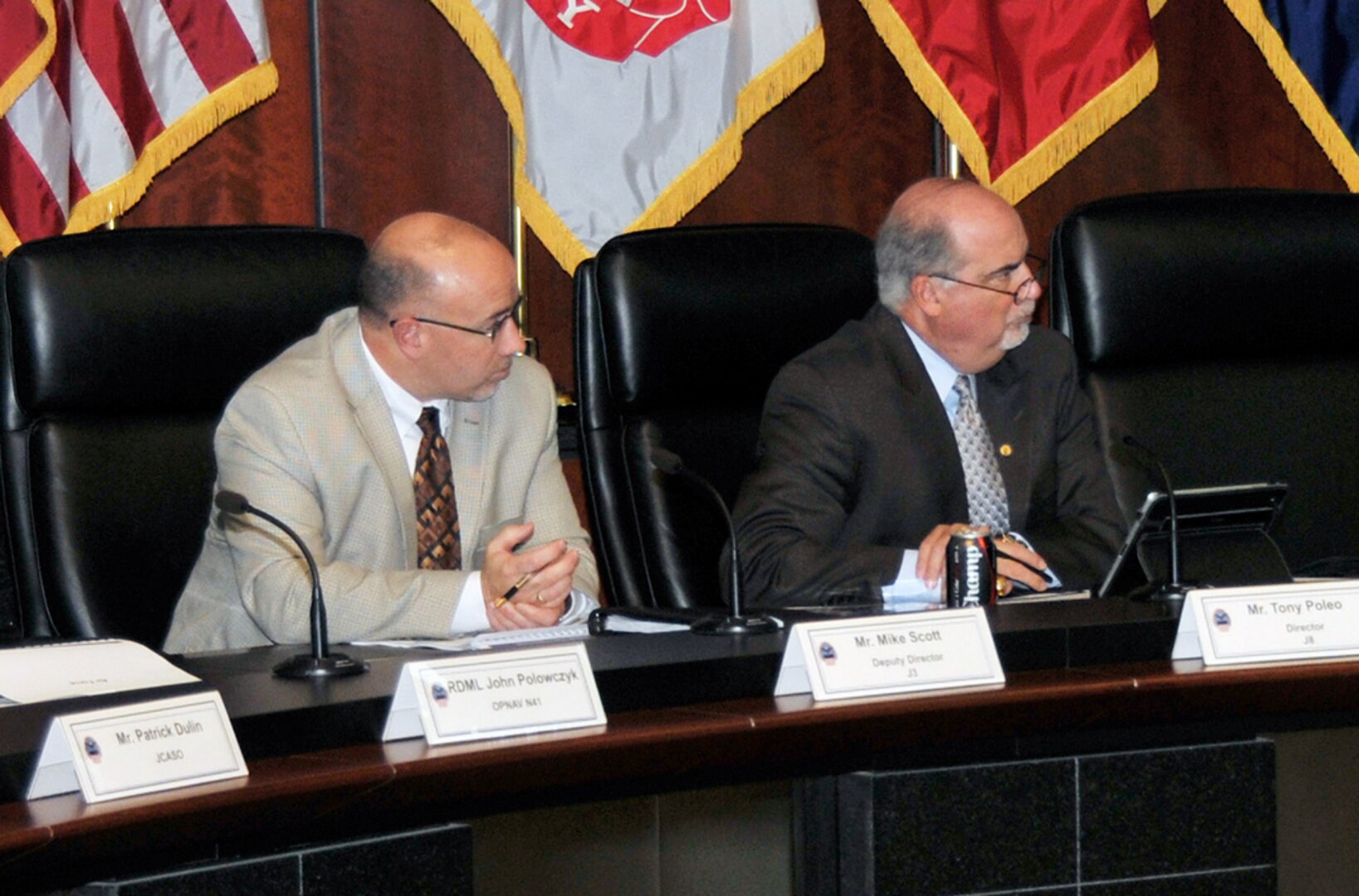 Mike Scott, deputy director of Defense Logistics Agency Logistics Operations, (left) and Tony Poleo, DLA Finance director, listen to attendees during Cost Summit IV Nov. 9 at the McNamara Headquarters Complex. The summit explained pricing to military customers and enhanced transparency between DLA and the Department of Defense.