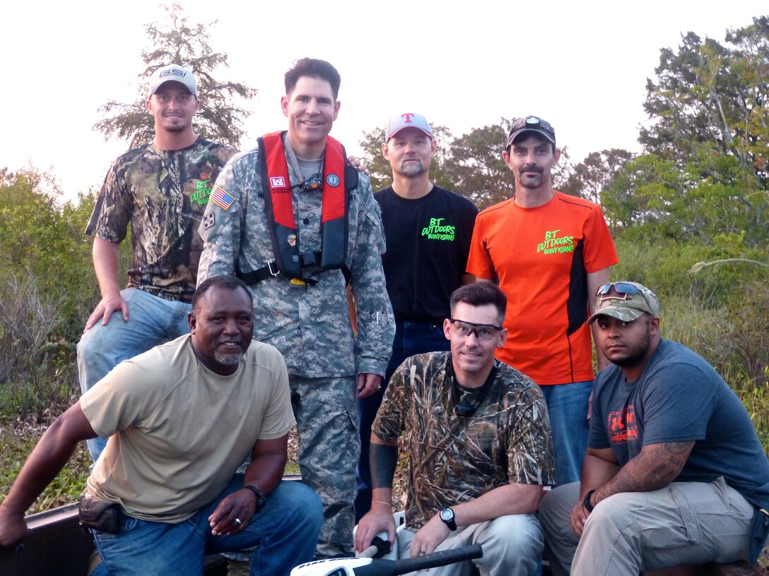 Fort Worth District deputy commander, Lt. Col. Clay Morgan poses with wounded warriors during an alligator hunt at B.A. Steinhagen Lake, near Jaspar, Texas.