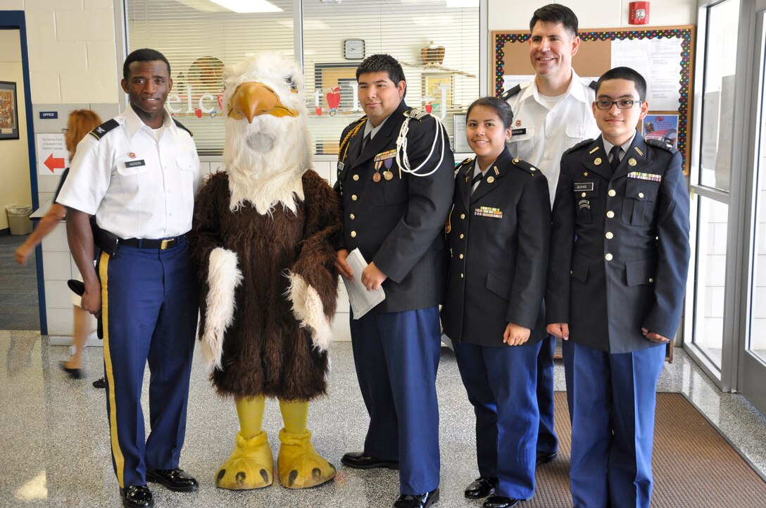 Fort Worth District commander and deputy pose with JROTC students before the "Project Lead the Way" program with the Fort Worth Independent School District.