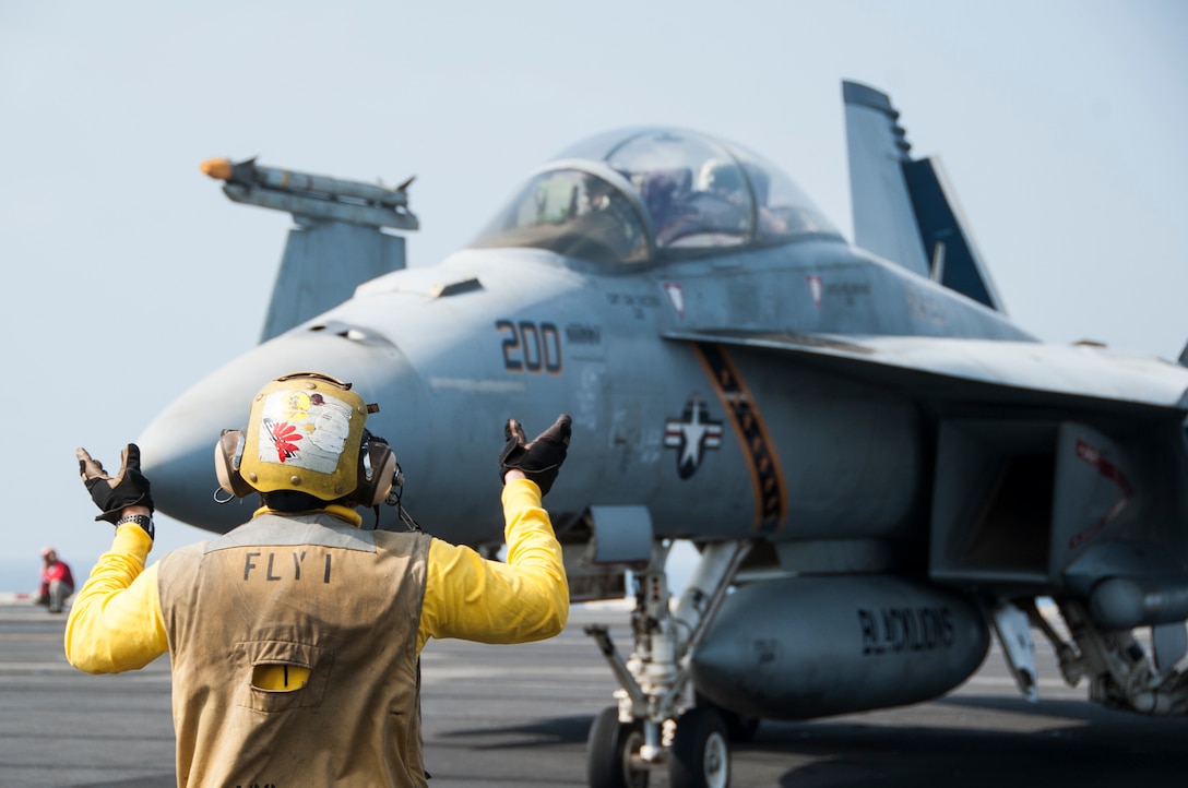 An F/A-18F Super Hornet attached to Strike Fighter Squadron 213 taxis on the flight deck of the aircraft carrier USS George H.W. Bush, Nov. 16, 2015. George H.W. Bush is supporting maritime security operations, strike operations in Iraq and Syria as directed, and theater security cooperation efforts in the U.S. 5th Fleet area of responsibility. U.S. Navy photo by Petty Officer 3rd Class Brian Stephens