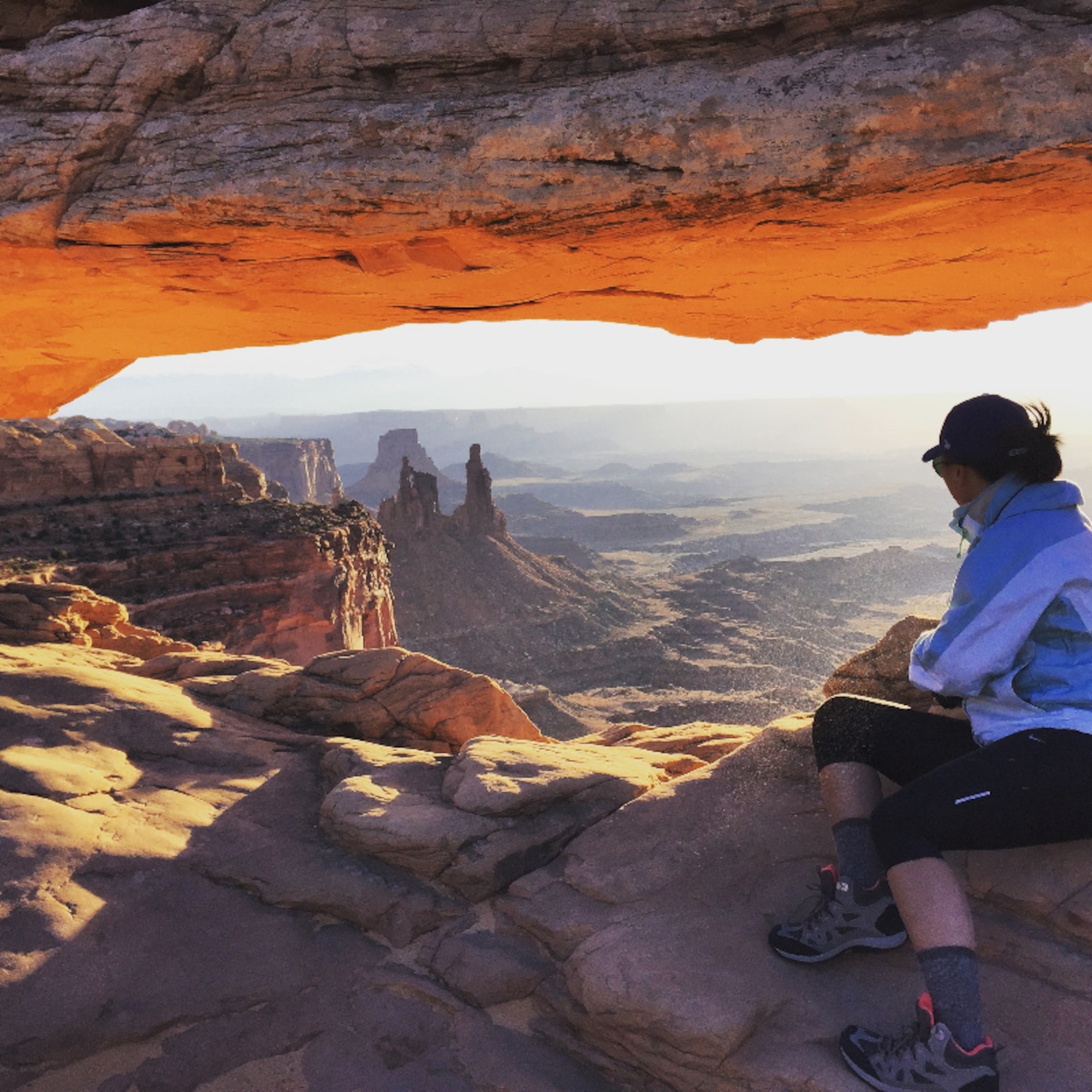 Senior Airman Grace Lee, 56th Fighter Wing Public Affairs photojournalist, looks over the view sitting underneath Mesa Arch Nov. 3 in Canyonlands National Park in Utah. Mesa Arch is famous for its view, especially during sunrise. (U.S. Air Force photo by Senior Airman Grace Lee)  