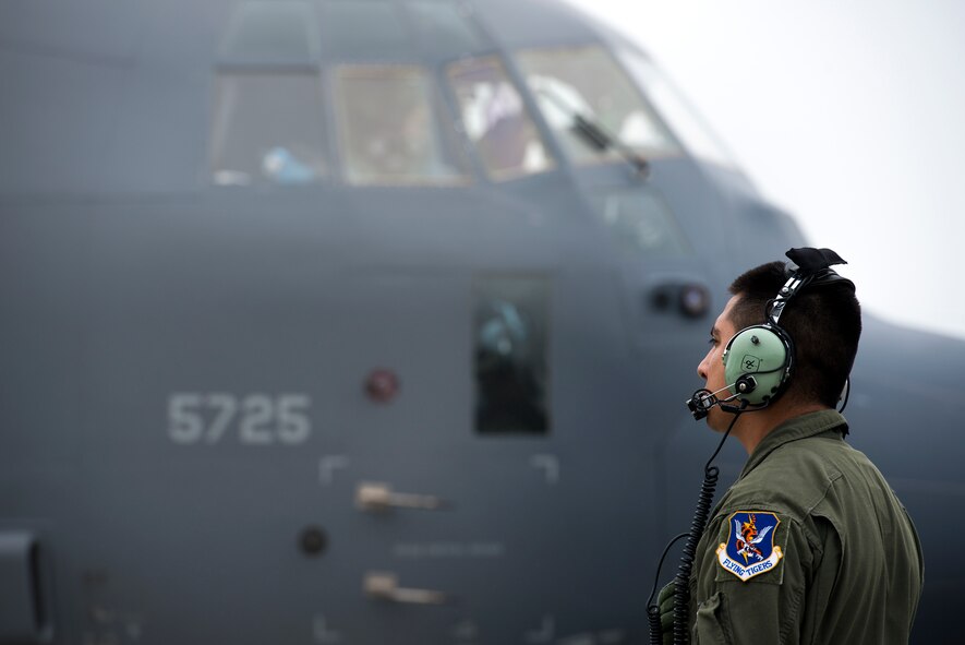 U.S. Air Force Staff Sgt. Edgar Elizalde, 71st Rescue Squadron loadmaster, watches as the engines start-up on an HC-130J Combat King II, Nov. 10, 2015, at Moody Air Force Base, Ga. During pre-flight inspections, loadmasters complete checklists to ensure proper procedure is being followed. (U.S. Air Force photo by Senior Airman Ryan Callaghan/Released)

