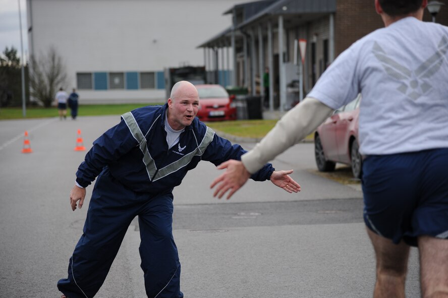 U.S. Air Force Lt. Col. Bryan France, 74th Expeditionary Fighter Squadron commander, reaches out to slap hands with an Airman approaching the finish line during the annual Run for Veteran’s 4.5K fun run at Amari Air Base, Estonia Nov. 13, 2015.  Nearly 300 members of the U.S. Air Force, Estonian defense forces, and German air force participated in the annual event to raise awareness for Estonian wounded warriors.  (U.S. Air Force photo by Andrea Jenkins/Released)