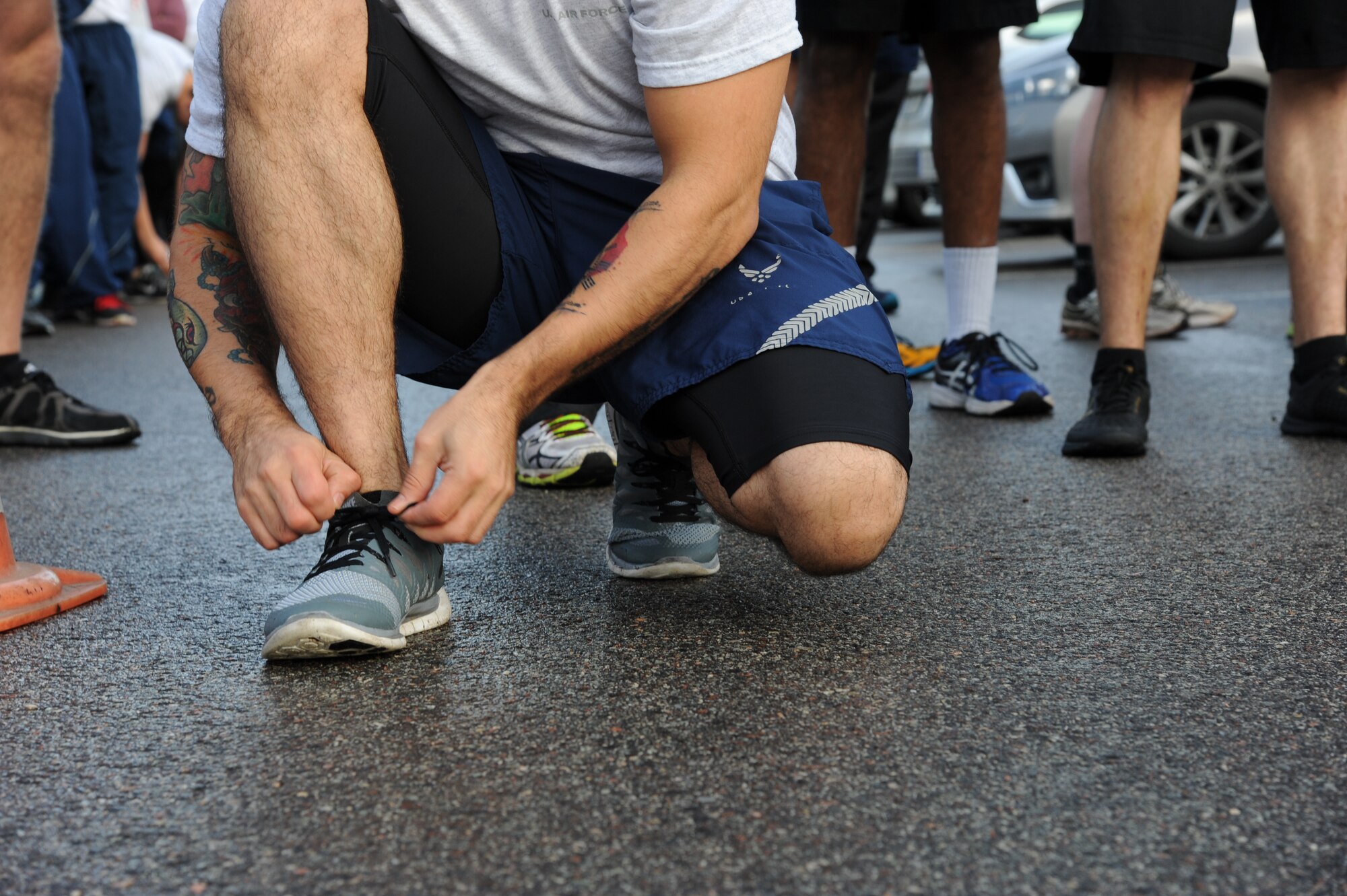U.S. Air Force Staff Sgt. Cedric Abolos, 74th Expeditionary Fighter Squadron, tightens his show lace before the start of the annual Run for Veteran’s 4.5K fun run at Amari Air Base, Estonia Nov. 13, 2015. Abolos, a California native, is a 74th EFS weapons load crew team chief deployed from Moody Air Force Base, Ga. (U.S. Air Force photo by Andrea Jenkins/Released)