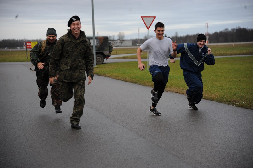 U.S. Air Force and German air force Airmen race toward the finish line at the annual Run for Veteran’s 4.5K fun run at of the at Amari Air Base, Estonia Nov. 13, 2015. Nearly 300 members of the U.S. Air Force, Estonian defense forces, and German air force participated in the annual event to raise awareness for Estonian wounded warriors.  (U.S. Air Force photo by Andrea Jenkins/Released)