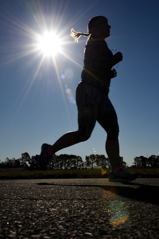 A runner reaches the 6-mile mark of the Run for the Fallen Half-Marathon, Nov. 14, 2015, at Seymour Johnson Air Force Base, North Carolina. The 13.1-mile course included a stretch on the flightline where participants ran on the same runway that the 4th Fighter Wing’s F-15E Strike Eagles takeoff and land daily. (U.S. Air Force photo/Senior Airman Brittain Crolley)