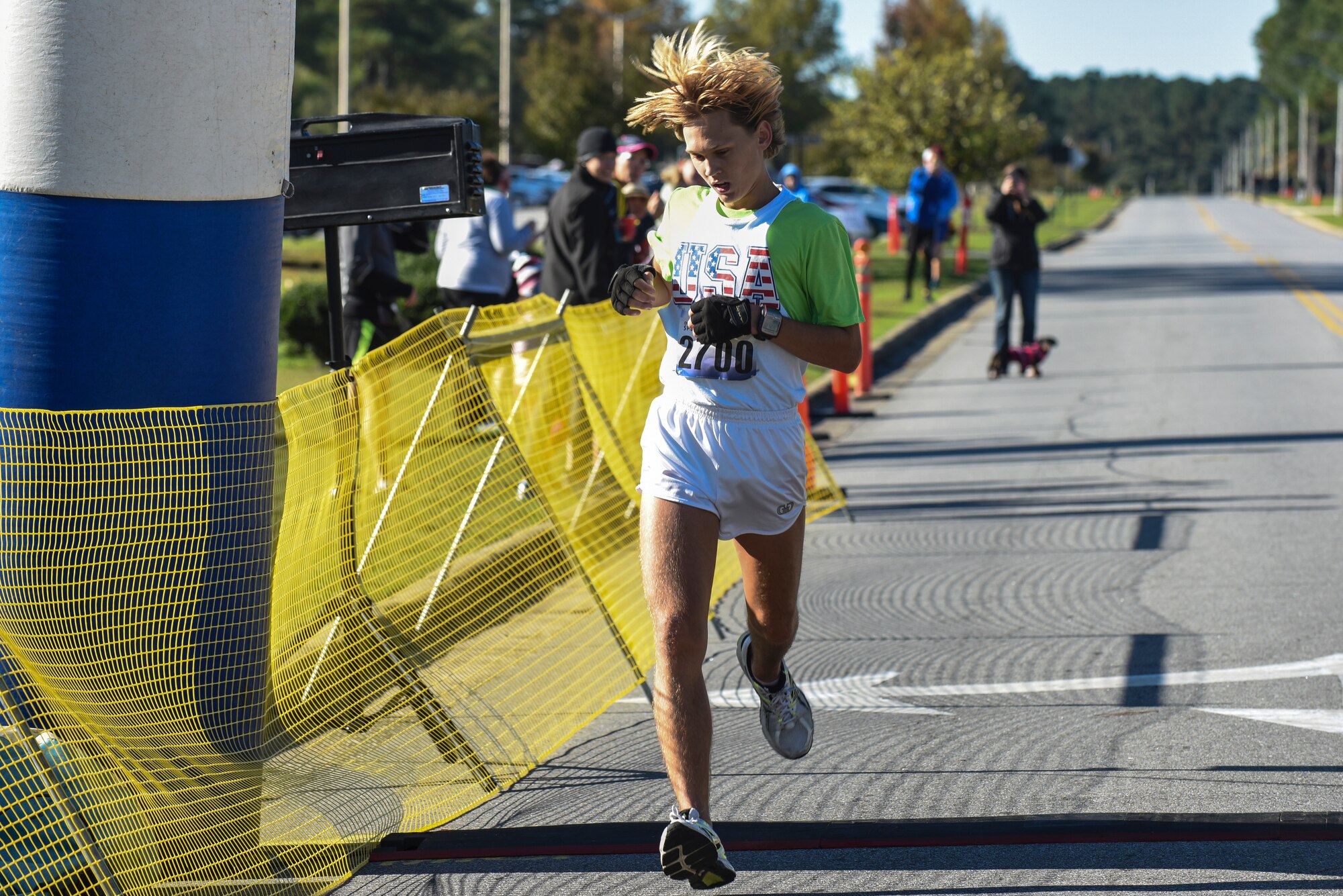 Joseph Mooneyham finishes first in the half-marathon during the Run for the Fallen Half-Marathon/5K, Nov. 14, 2015, at Seymour Johnson Air Force Base, North Carolina. The top three male and female winners were announced and given prizes at the conclusion of the event. (U.S. Air Force photo/Airman Shawna L. Keyes)