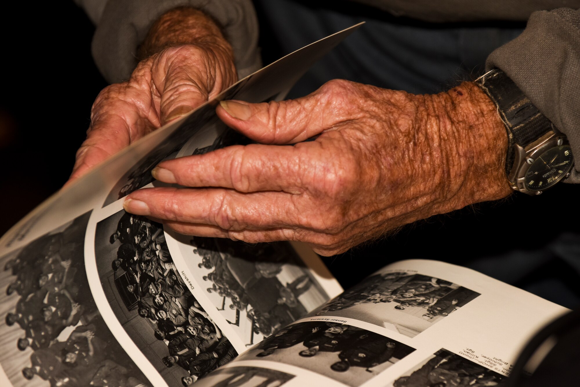 Aaron Norris, a retired Air Force member, looks through the Seymour Johnson Air Force Base 1976 bicentennial year book during the Retiree Appreciation Night event, Nov. 12, 2015, at Seymour Johnson Air Force Base, North Carolina. During the event, retirees got a chance to meet up with both old and new faces and discuss the new retiree initiative within the Make It Better campaign. (U.S. Air Force photo/Airman Shawna L. Keyes)