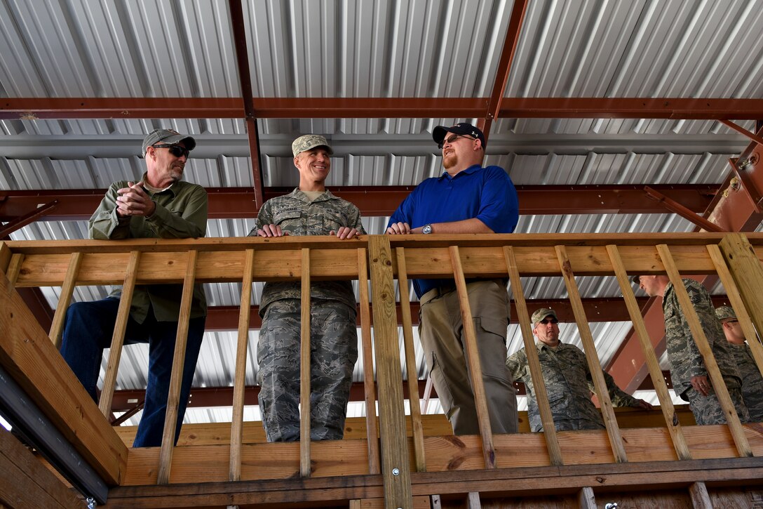 Andy Anderson (left), 4th Security Forces Squadron lead security forces instructor, Chief Master Sgt. Steve McDonald (middle), Air Combat Command command chief, and Maxie Henderson, 4th SFS resource advisor, discuss the 4th SFS shoot house and move-shoot-communicate range, Nov. 12, 2015, at Seymour Johnson Air Force Base, North Carolina. Anderson enlightened McDonald on the 4th SFS shoot house and range, which was the first fully functional range training complex in ACC. (U.S. Air Force photo/Senior Airman Aaron J. Jenne)