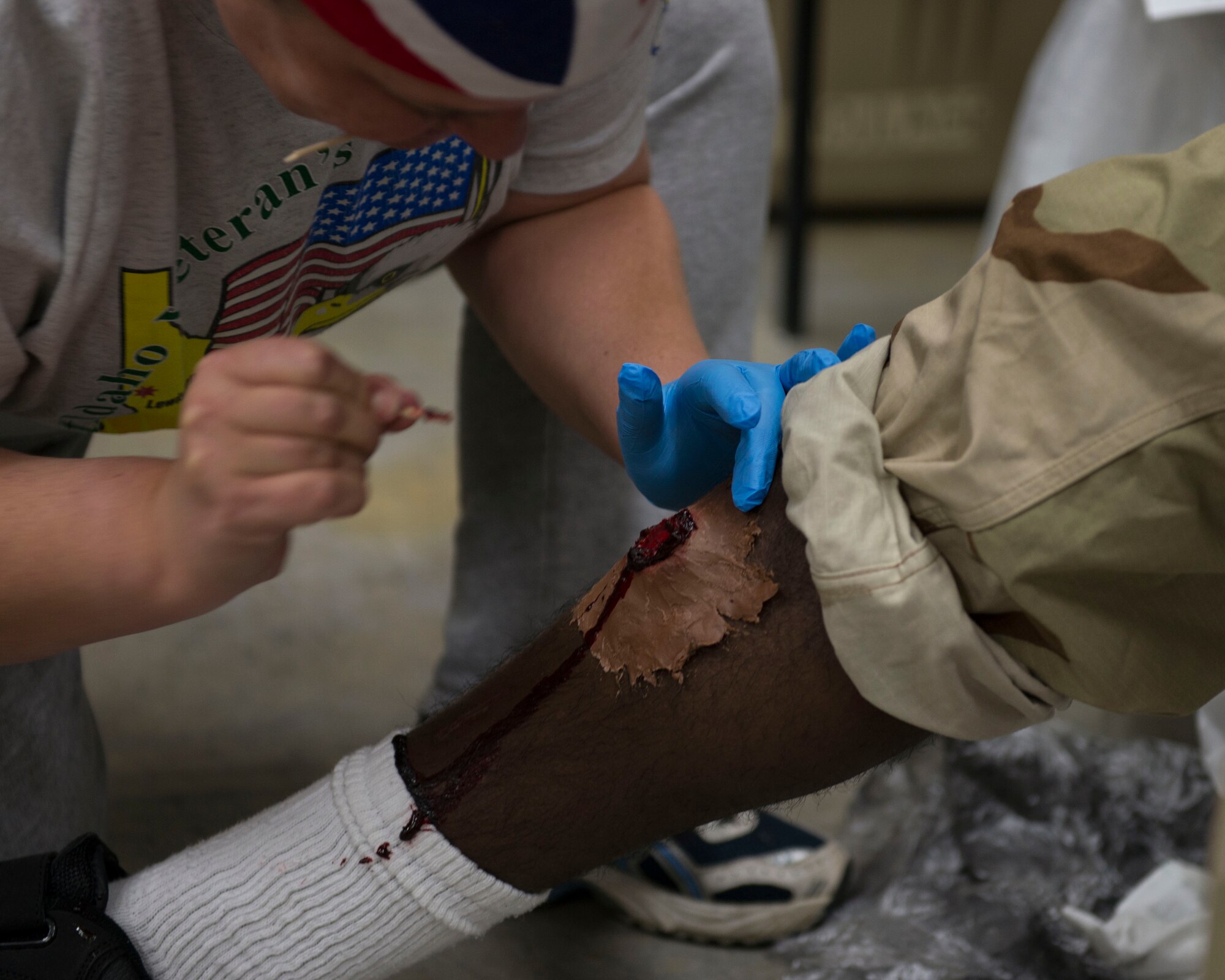 Retired Master Sgt. Veronica Rowlett applies moulage to Airman 1st Class
Kevin Joseph's leg at Mountain Home Air Force Base, Idaho, Nov. 5, 2015.
Moulage was used to simulate realistic battlefield injuries during
Gunfighter Flag 16-1. (U.S. Air Force photo by Airman 1st Class Jessica H.
Evans)
