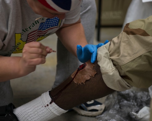 Retired Master Sgt. Veronica Rowlett applies moulage to Airman 1st Class
Kevin Joseph's leg at Mountain Home Air Force Base, Idaho, Nov. 5, 2015.
Moulage was used to simulate realistic battlefield injuries during
Gunfighter Flag 16-1. (U.S. Air Force photo by Airman 1st Class Jessica H.
Evans)
