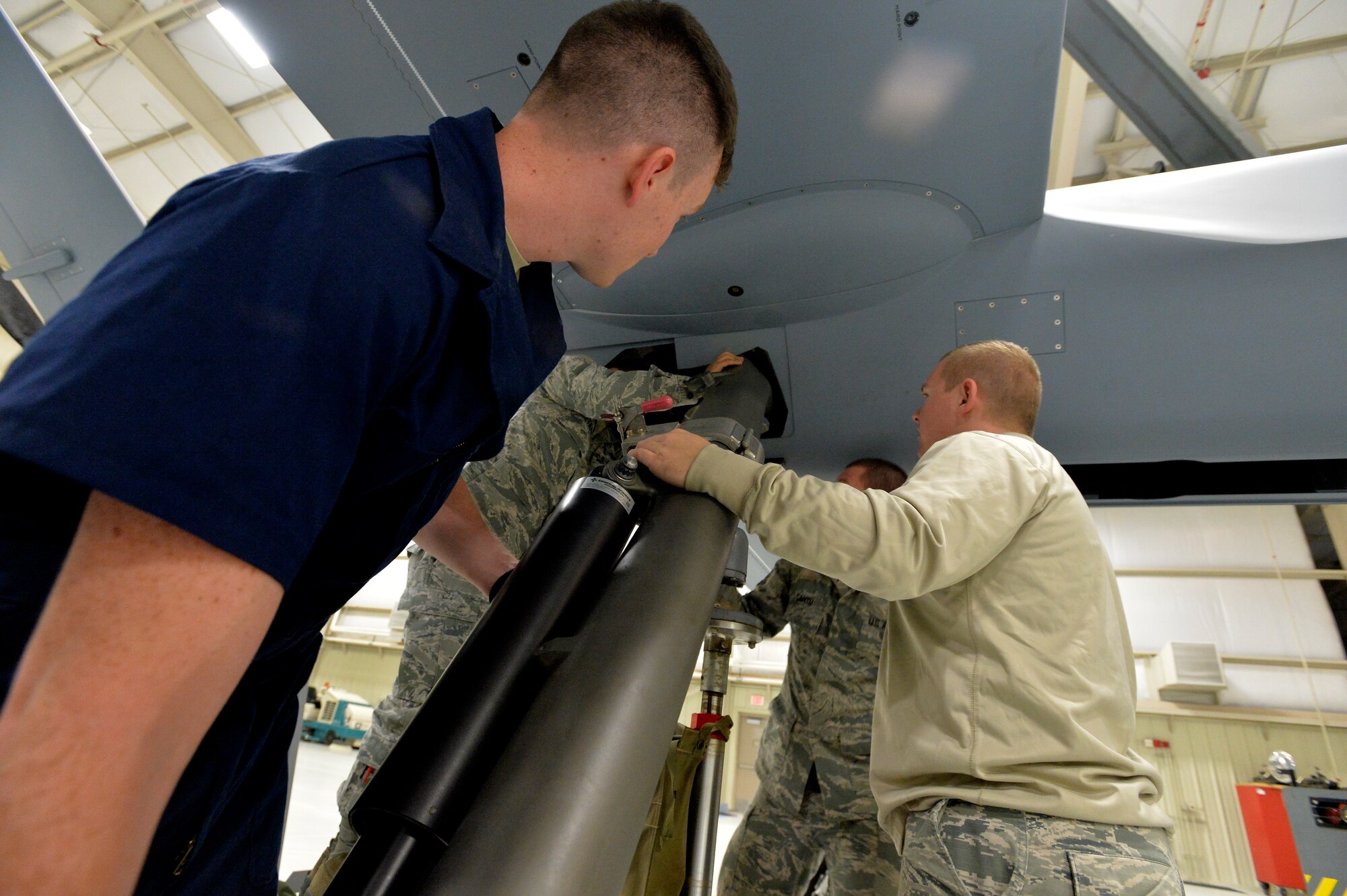 Instructors and Students place landing gear into an aircraft at Creech Air Force Base, Nevada. Nov. 6, 2015. Det 13 OL-A provides maintenance training to the MQ-1/9 enterprise. Crew Chiefs, Avionics, Weapons and Communications courses are offered from our staff of 6 AETC instructors
