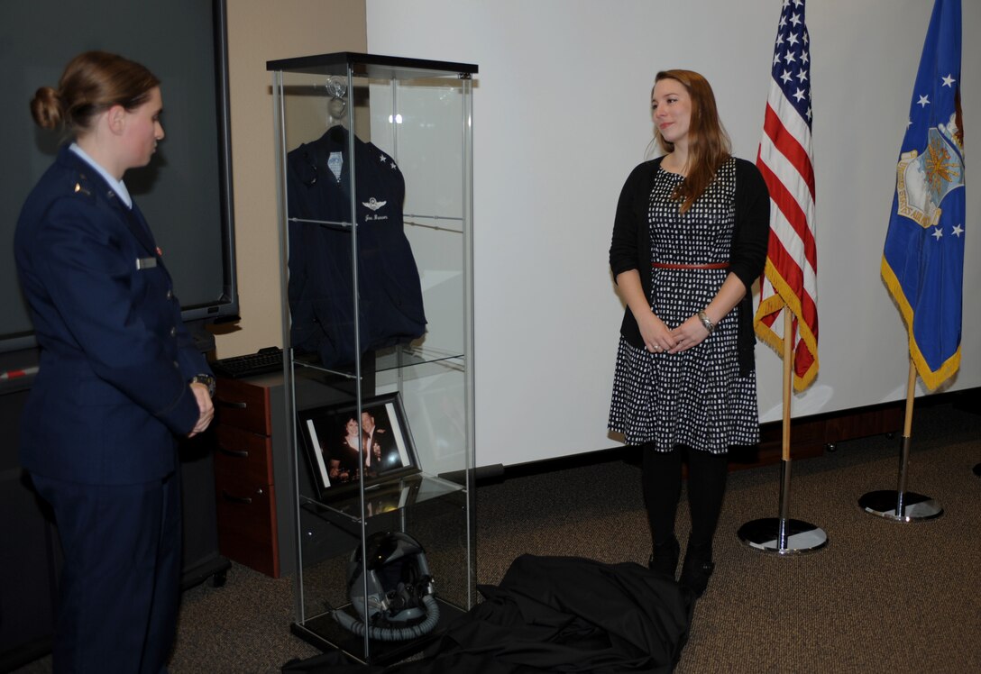 First Lt. Amela Kamencic, left, 28th Civil Engineer Squadron requirements and optimizations officer in charge, unveils a memorial case with Emily Brown, right, daughter of the late Maj. Gen. Joseph D. Brown IV, during the Mission Employment Center dedication ceremony at Ellsworth Air Force Base, S.D., Nov. 10, 2015. The MEC was dedicated to Brown, a former group and wing commander, for his positive and lasting impression on Ellsworth. (U.S. Air Force photo by Airman 1st Class Denise M. Nevins/Released)