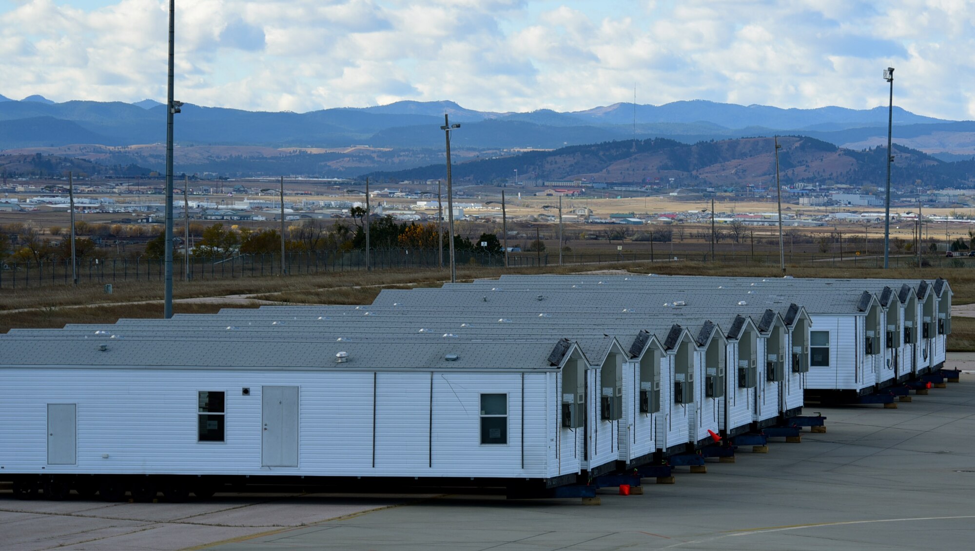 Manufactured homes provided by the Federal Emergency Management Agency to aid Pine Ridge Indian Reservation residents are staged at Ellsworth Air Force Base, S.D., Nov. 5, 2015. Ten of the homes were designed to meet the Uniform Federal Accessibility Standards, providing housing for those with access and functional needs. (U.S. Air Force photo by Airman 1st Class James L. Miller/Released)