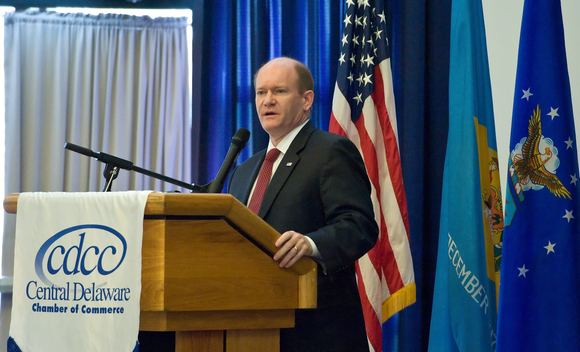 Sen. Chris Coons, D-Del., reminds attendees at the 2015 Military Construction briefing and breakfast about the importance of the men and women assigned to the 436th and 512th Airlift Wings working together that make up Team Dover, Nov. 9, 2015, at The Landings on Dover Air Force Base, Del. Coons stated that Dover AFB contributes $630 million to the local economy. (U.S. Air Force photo/Roland Balik)