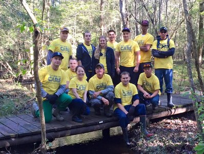 Members from Joint Base Charleston pose for a group photo after clearing and repairing trails in the Francis Marion National Forest, S.C. on Nov. 13, 2015. Thirteen people donated five hours of their time each in order to put three bridges back into place and clear the trails of leaves and debris caused from recent flooding in the Lowcountry. This volunteer event was a part of this year’s United Way Day of Caring. (Courtesy photo)
