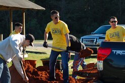 Sailors assigned to Naval Nuclear Power Training Command on Joint Base Charleston Weapons Station shovel mulch while beautifying a YMCA baseball field in Summerville, S.C., Nov. 13, 2015. More than 3,500 NNPTC staff and students volunteered during the 2015 Trident United Way Day of Caring. (U.S. Navy photo / Chief Machinist’s Mate Jody Greenhill)