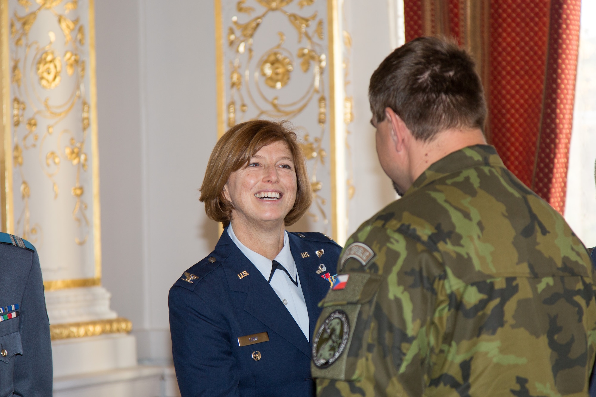 Colonel Jill Long, Deputy Director Plans and Program Analyses, congratulates Sgt. 1st Class Pavel Zelenka from the Czech Republic Air Force on his completion of the first IEAFA combined international officer and NCO PME course during graduation in Sofia, Bulgaria, Nov. 13, 2015.  Twenty-three students from Bulgaria, Czech Republic, Estonia, and Hungary participated in this inagural course. (U.S. Air Force photo/SMSgt Travis Robbins/Released)