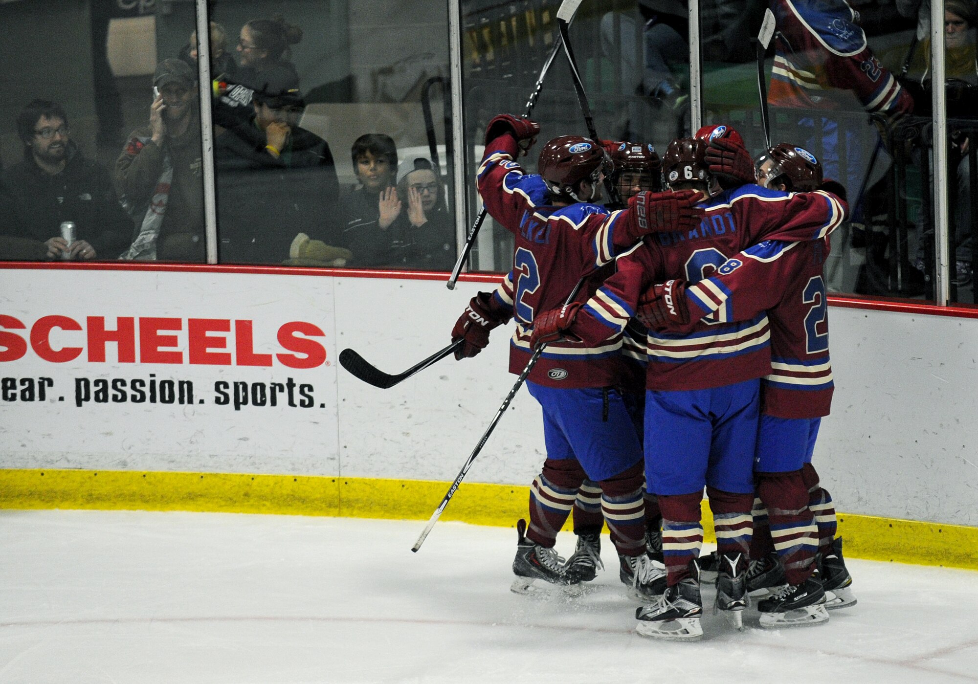 Members from the Minot Minotauros celebrate after one of their teammates made a goal during a game against the Bismarck Bobcats in Minot, N.D. Nov. 10, 2015. The game honored military veterans for Veteran’s Day. (U.S. Air Force photo by Staff Sgt. Chad Trujillo)