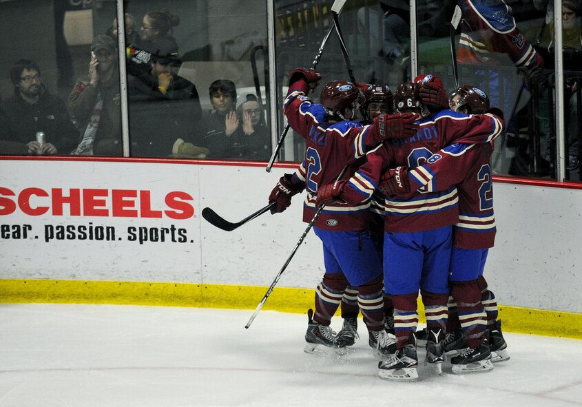Members from the Minot Minotauros celebrate after one of their teammates made a goal during a game against the Bismarck Bobcats in Minot, N.D. Nov. 10, 2015. The game honored military veterans for Veteran’s Day. (U.S. Air Force photo by Staff Sgt. Chad Trujillo)
