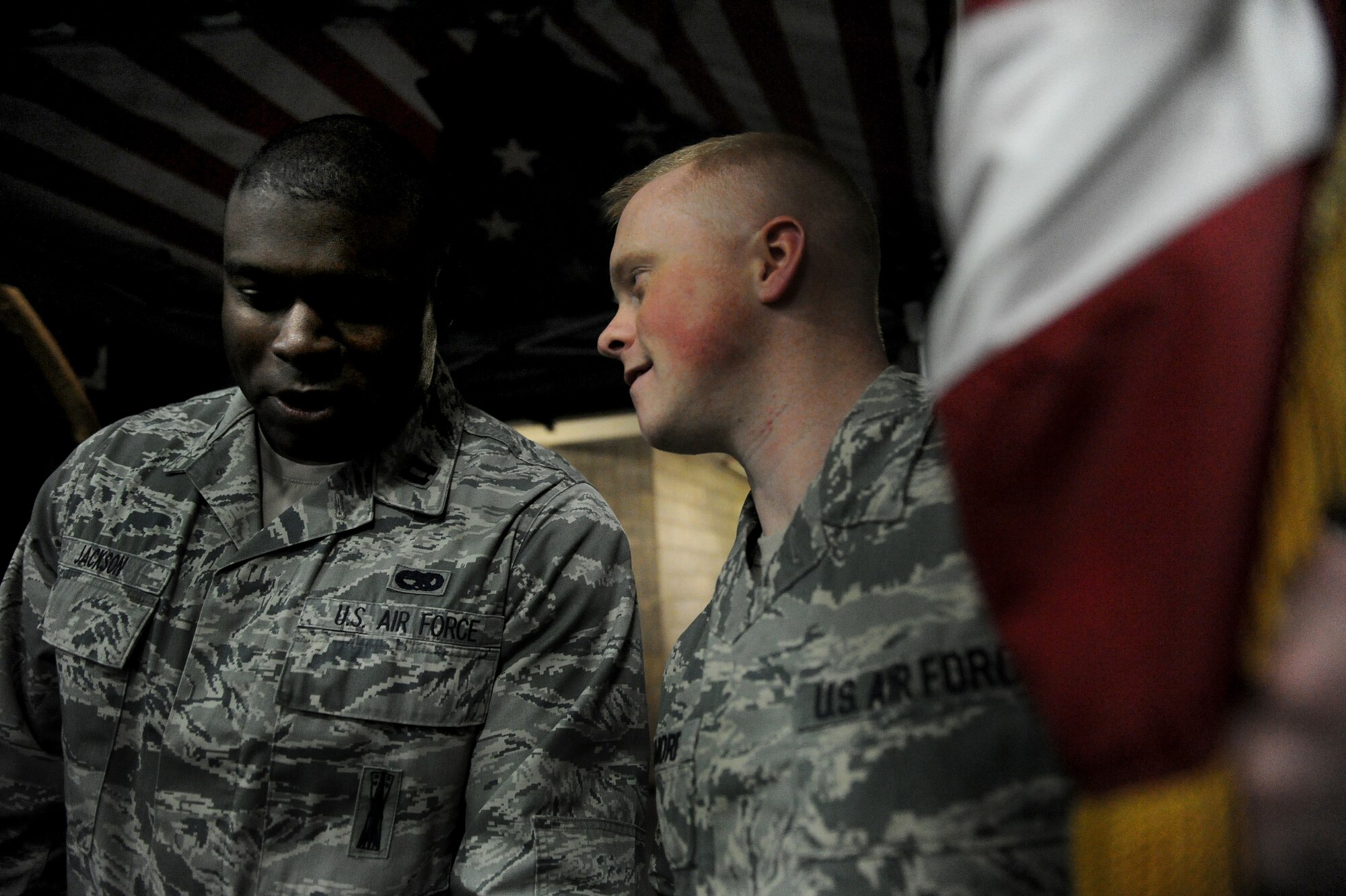 Capt. Lamin Jackson talks with Senior Airman Brandon Gilmore, both 91st Maintenance Sq. at the Minot Minotaurous game in Minot, N.D. Nov. 10, 2015. Gilmore reenlisted during the game where veterans were honored for Veteran’s Day. (U.S. Air Force photo by Staff Sgt. Chad Trujillo)