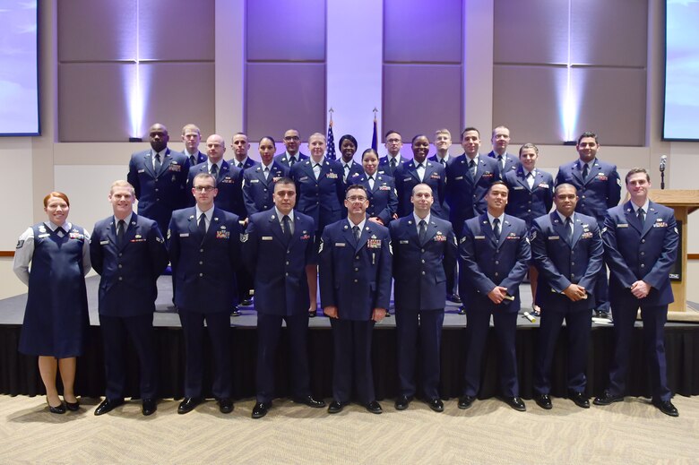 More than 50 members of Team Buckley accepted diplomas after graduating from the Community College of the Air Force Nov. 16, 2015, on Buckley Air Force Base, Colo. For the first time, Buckley holds classes on base so that service members have the ability to finish their associate degrees without having to leave the installation. (U.S. Air Force photo by Airman 1st Class Luke W. Nowakowski/Released)