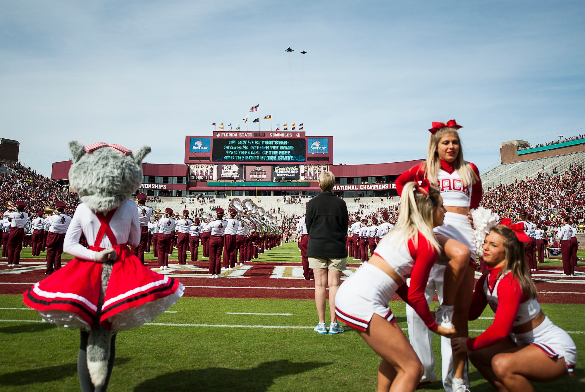 An F-15E Strike Eagle and an F-16 Fighting Falcon from the 40th Flight Test Squadron perform a flyover during Florida State University’s Homecoming football game in Tallahassee, Fla., Nov. 14. At the end of the third quarter the air crew was recognized and thanked for the flyover and their service to the country while the crowd chanted USA! USA! (U.S. Air Force Photo/Ilka Cole)