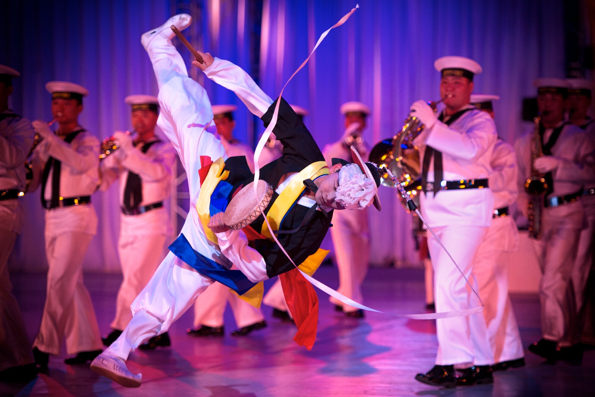 A Republic of Korea Navy Band performer dances during the Japan Self-Defense Force Marching Festival at the Nippon Budokan Arena in Tokyo, Japan, Nov. 13, 2015. The festival allowed all of the bands the opportunity to engage and interact with one another. (U.S. Air Force photo by Airman 1st Class Delano Scott/Released)    