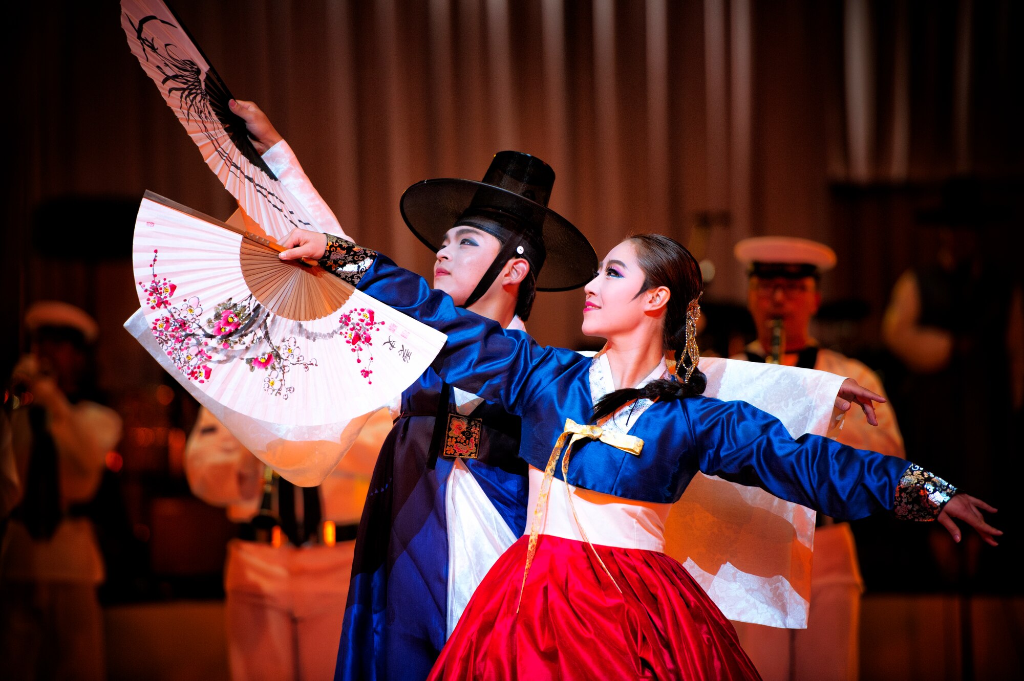 Republic of Korea Navy Band performers dance during the Japan Self-Defense Force Marching Festival at the Nippon Budokan Arena in Tokyo, Japan, Nov. 13, 2015. The three-day festival featured performances from 13 different bands, representing three different nations – the U.S., Japan, and South Korea. (U.S. Air Force photo by Airman 1st Class Delano Scott/Released)   