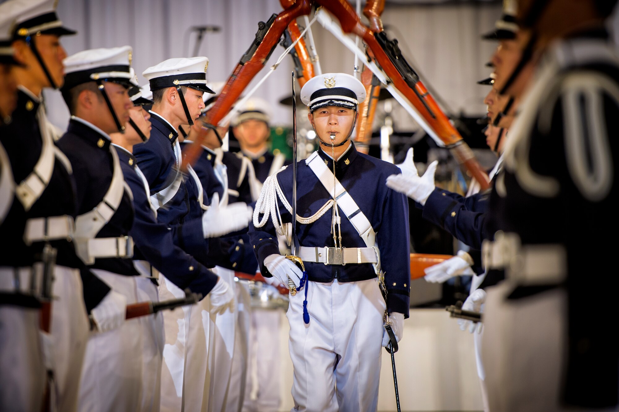 National Defense Academy Guard of Honor members perform a drill during the Japan Self-Defense Force Marching Festival at the Nippon Budokan Arena in Tokyo, Japan, Nov. 13, 2015. The three-day festival featured performances from 13 different bands, representing three different nations – the U.S., Japan, and South Korea. (U.S. Air Force photo by Airman 1st Class Delano Scott/Released)     