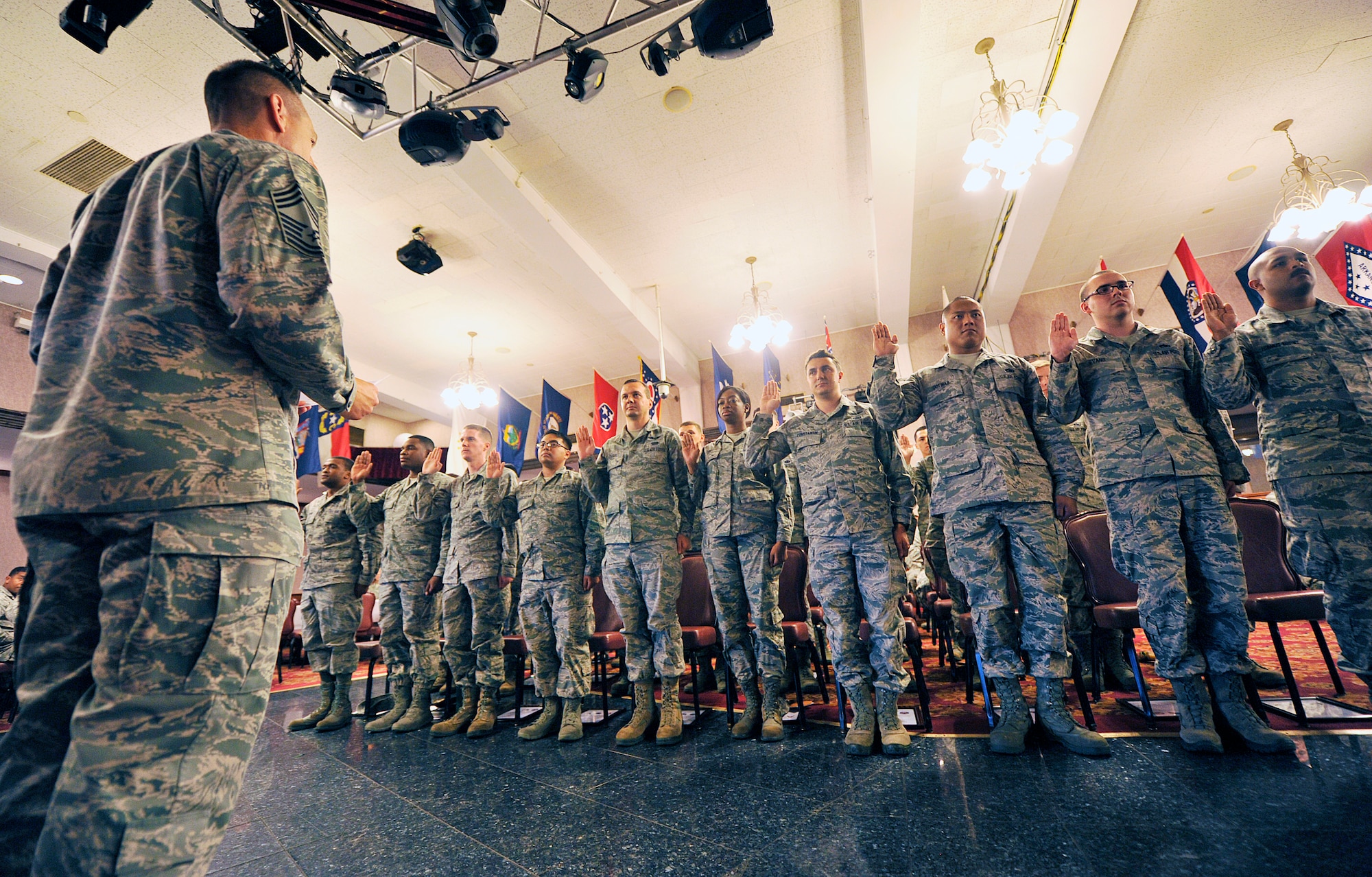 U.S. Air Force Chief Master Sgt. Kenneth Boteler, 18th Operations Group superintendent, leads newly promoted staff sergeants in an oath during a quarterly NCO induction ceremony at the Rocker NCO Club, Nov. 16, 2015, at Kadena Air Base, Japan. During the ceremony, 29 NCOs from Team Kadena took part in a time honored tradition symbolizing their change from being a follower to becoming a leader. (U.S. Air Force photo by Naoto Anazawa)