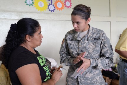 U.S. Army Sgt. Stephanie Tucker, Joint Task Force-Bravo radiologist technician, gives a Honduran woman medication instructions during a medical partnership exercise in the Olancho Department, Honduras, Nov. 14, 2015. Tucker is as native of Dallas, Texas and helped augment the stand-up pharmacy during the recent MEDRETE in Olancho. (U.S. Air Force Photo by Senior Airman Westin Warburton/Released)