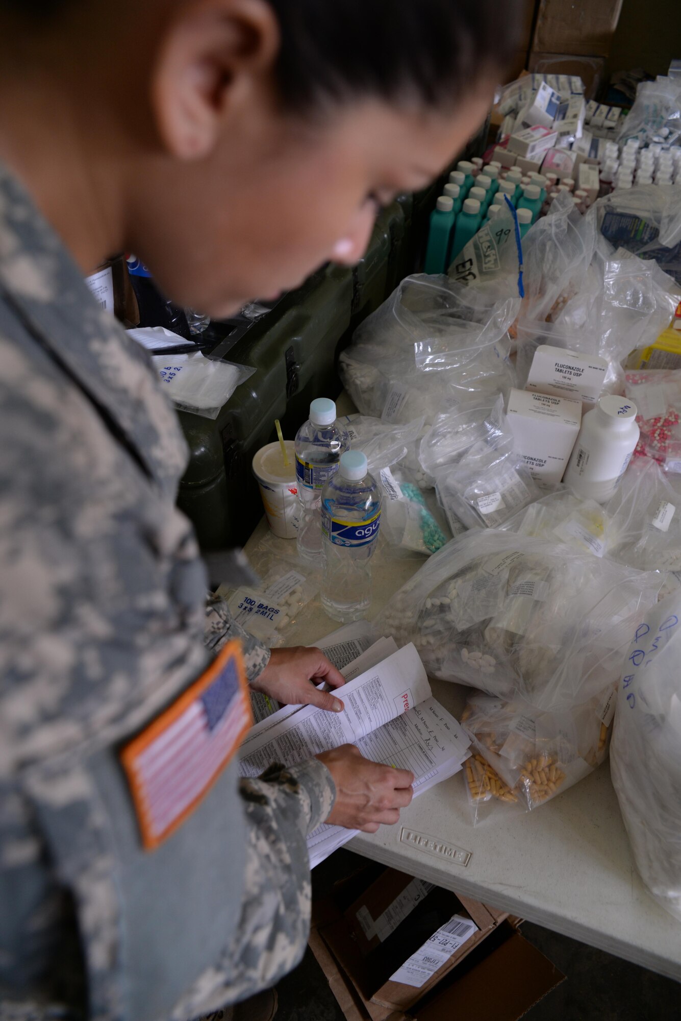 U.S. Army Sgt. Stephanie Tucker, Joint Task Force-Bravo radiologist technician, looks through prescription papers during a medical partnership exercise in the Olancho District, Honduras, Nov. 14, 2015. Tucker is part of the medical element at Soto Cano Air Base and augmented the pharmacy during her  time in Olancho. (U.S. Air Force Photo by Senior Airman Westin Warburton/Released)


