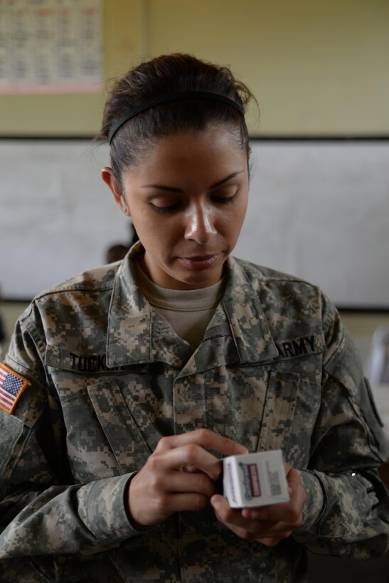 U.S. Army Sgt. Stephanie Tucker, Joint Task Force-Bravo radiologist technician, provides support as she augments a stand-up pharmacy at a medical partnership exercise in the Olancho Department, Honduras, Nov. 14, 2015. Tucker, a Dallas, Texas native, is part of the medical element at Soto Cano Air Base and also participated in a medical readiness training exercise the two previous days. (U.S. Air Force Photo by Senior Airman Westin Warburton/Released)