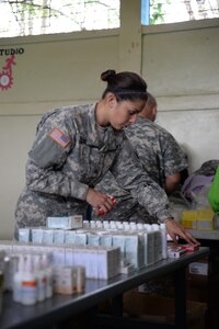 U.S. Army Sgt. Stephanie Tucker, Joint Task Force-Bravo radiologist technician, works in a stand-up pharmacy she augmented during a medical partnership exercise in the Olancho Department, Honduras, Nov. 14, 2015. Tucker is part of the medical element at Soto Cano Air Base and also participated in a medical readiness training exercise the two previous days. (U.S. Air Force Photo by Senior Airman Westin Warburton/Released)