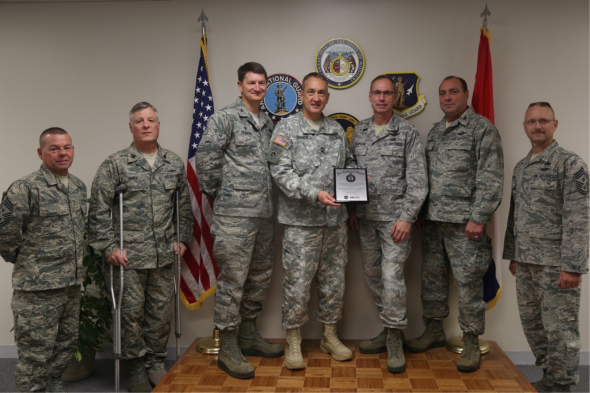 Maj. Gen. Steve Danner, the adjutant general of the Missouri National Guard, presented an award for achieving and maintaining 100 percent end strength for fiscal year 2014 to the commanders, command chiefs and representatives of the 131st Bomb Wing and the 139th Airlift Wing, Nov. 6, 2015 at the Missouri National Guard Headquarters in Jefferson City, Mo. (U.S. Army National Guard photo by Sgt. Mariah Best)
