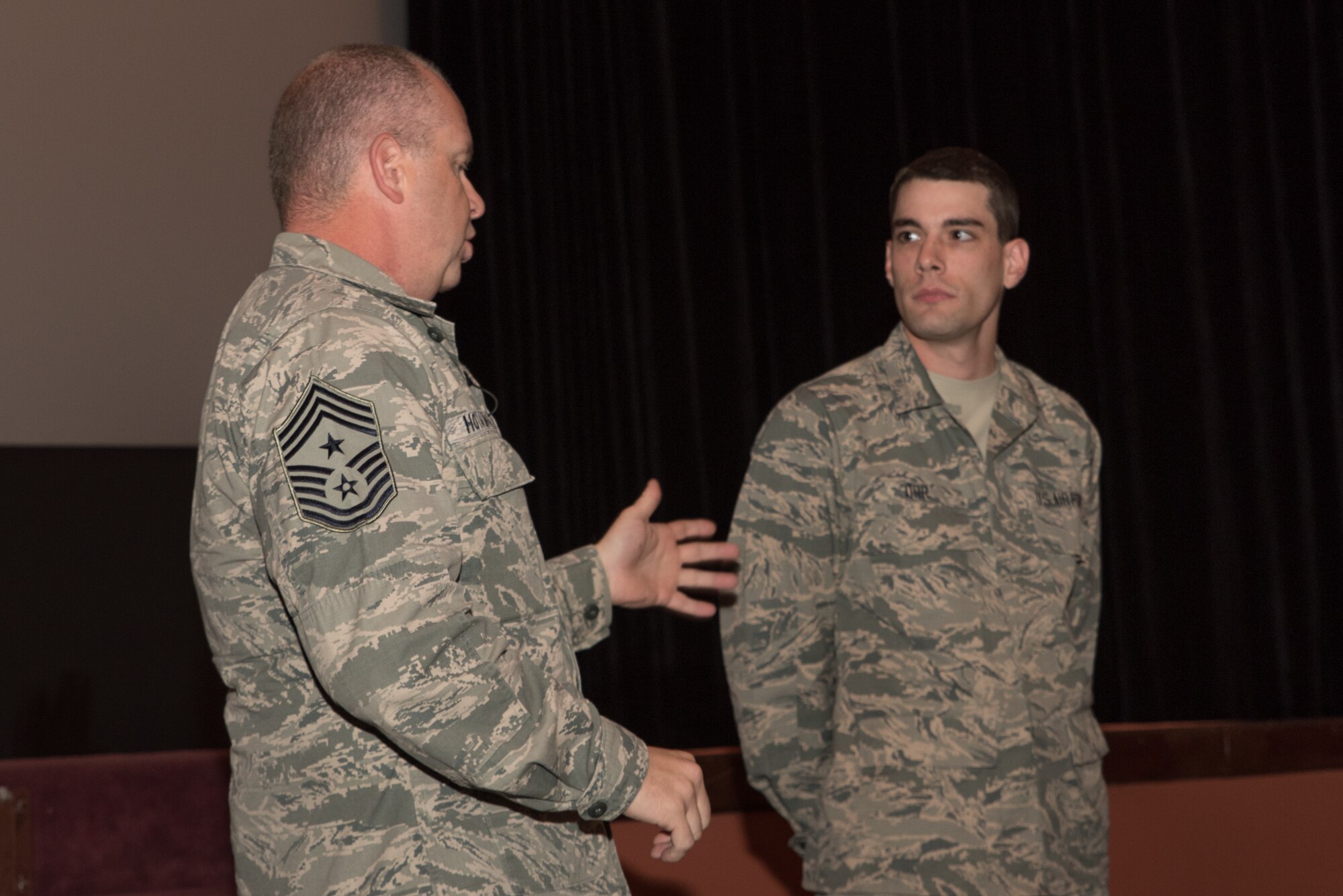 U.S. Air Force Chief Master Sgt. James W. Hotaling, command chief master sergeant of the Air National Guard presents a coin to Airman Basic Skylar Orr, Nov. 8, 2015 in Cheyenne, Wyoming. Hotaling gave a special message to Orr, who is a recent basic training graduate with honors and a cyber operator assigned to the 153rd Command and Control Squadron, Wyoming Air National Guard. (U.S. Air National Guard photo by Tech. Sgt. John Galvin/released)