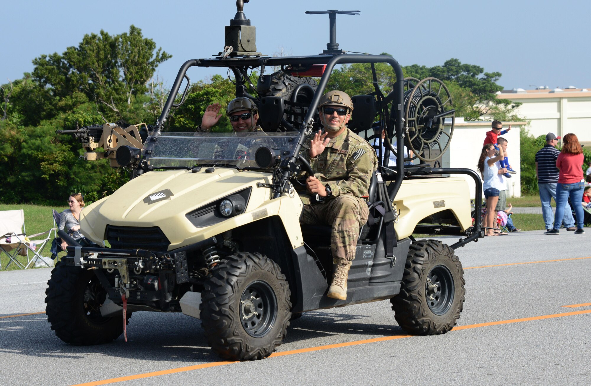 Two Airmen assigned to the 320th Special Tactics Squadron wave to the crowd during Kadena’s first Veterans Day parade held Nov. 11, 2015 at Kadena Air Base, Japan.  Service members from different branches of the United States military on Kadena Air Base, Japan, came together on Veterans Day to commemorate Veterans Day.  Veterans Day is held each year to honor the men and women, past and present, who have served in the military.  (U.S. Air Force photo by Tech. Sgt. Kristine Dreyer)