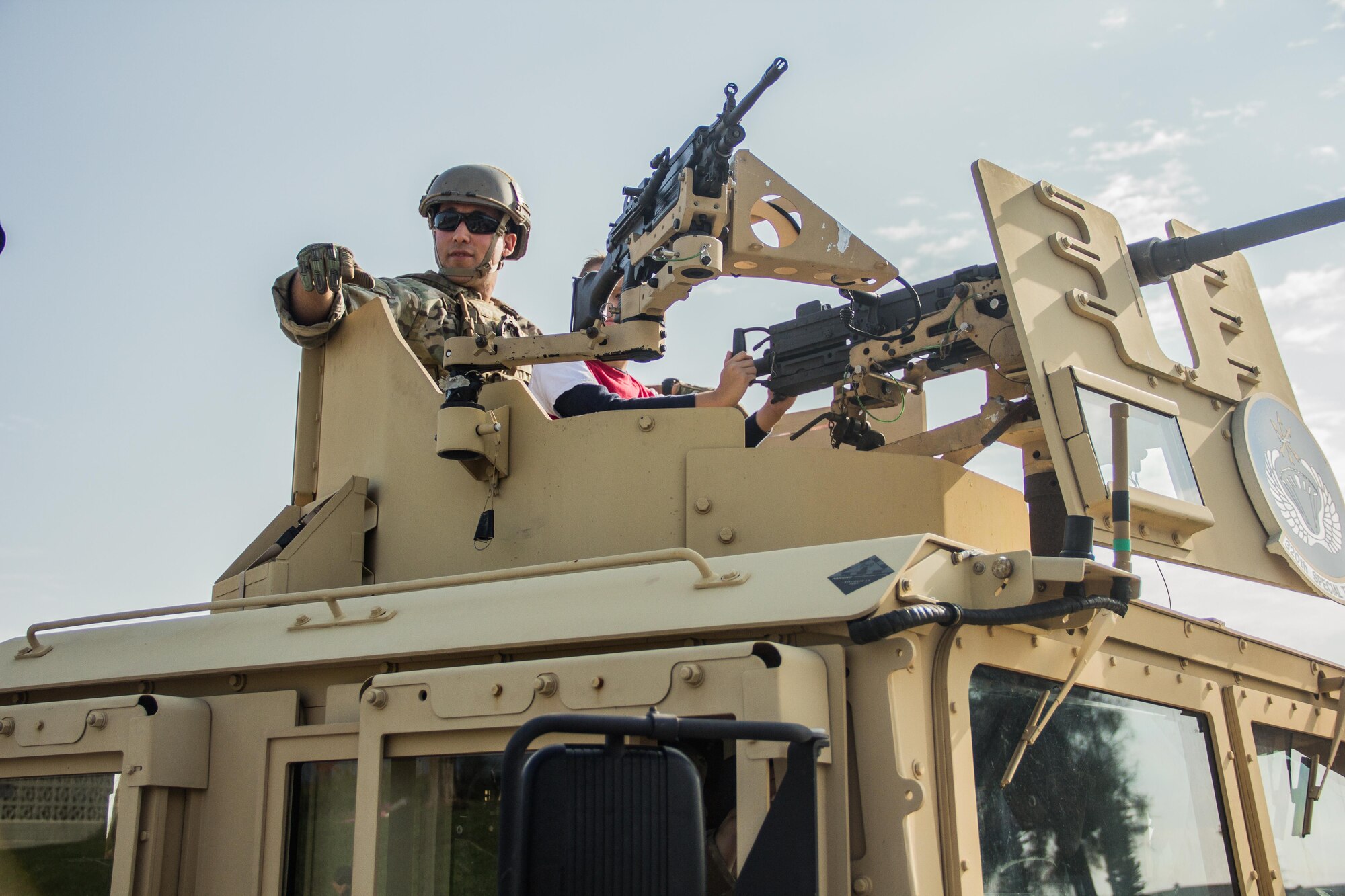 An Airman assigned to the 320th Special Tactics Squadron rides a Humvee during Kadena’s first Veterans Day parade held Nov. 11, 2015 at Kadena Air Base, Japan.  Service members from different branches of the United States military on Kadena Air Base, Japan, came together on Veterans Day to commemorate Veterans Day.  Veterans Day is held each year to honor the men and women, past and present, who have served in the military.  (U.S. Air Force photo by Senior Airman Bobby Jackson)