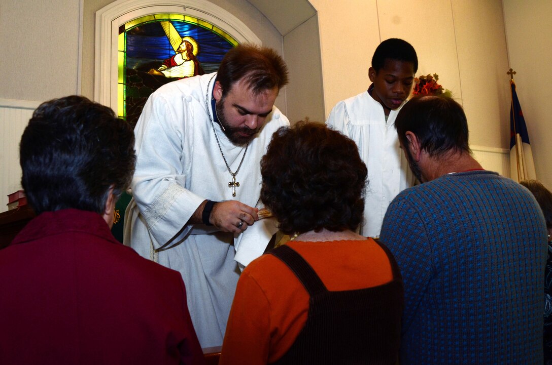 Stephen Woolverton, the pastor at Calvary United Methodist Church in Marydel, Md., passes out communion Nov. 8, 2015, with help from acolyte Maniyah Crain. Woolverton, who served on active duty in the Army and Navy, is seeking a commission as a chaplain in the Navy Reserve.