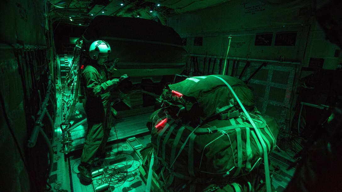 U.S. Marine Cpl. Lydia Judge, a crew master with Special-Purpose Marine Air-Ground Task Force Crisis Response-Africa, performs a final inspection of gear aboard a KC-130J Hercules, Nov. 9, in Zaragoza, Spain. The Marines spent a week training with Spanish counterparts, providing air delivery of gear and personnel.