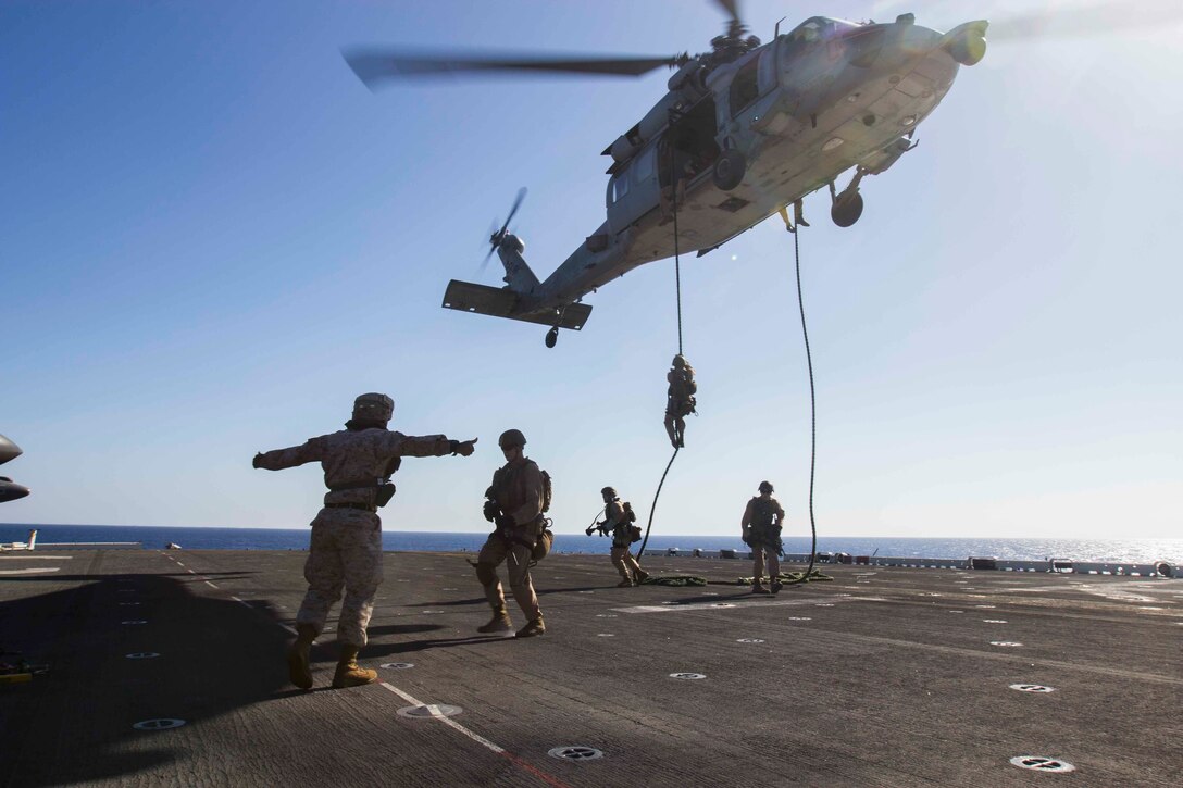 U.S. Marines conduct fast-rope training out of a SH-60 Seahawk helicopter aboard the amphibious assault ship USS Kearsarge in the North Red Sea, Nov. 5, 2015. The Marines are assigned to Weapons Company, Battalion Landing Team 2, 6th Battalion, 26th Marine Expeditionary Unit. The unit, embarked on the Kearsarge Amphibious Ready Group, is deployed to maintain regional security in the U.S. 5th Fleet area of operations. U.S. Marine Corps photo by Cpl. Jalen D. Phillips