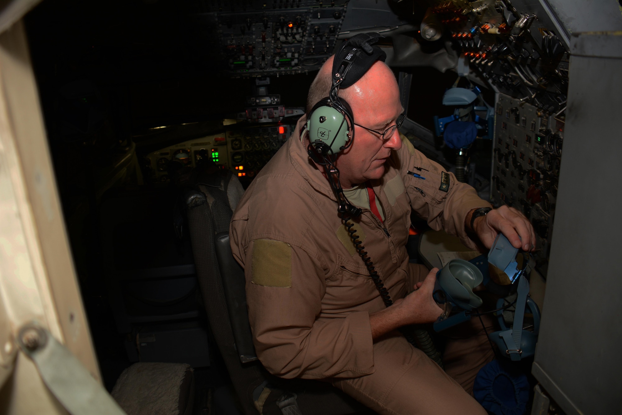 Master Sgt. Curtis Stark, 7th Expeditionary Air Combat Control Squadron superintendent, inspects an emergency oxygen mask during a pre-flight inspection in the cockpit of an E-8C Joint Surveillance Target Attack Radar System aircraft at Al Udeid Air Base, Qatar Nov. 14. Stark has deployed 17 times with JSTAR aircraft in support of contingency operations and has accumulated more than 4,000 combat flying hours. After nearly 30 years of service he plans to retire from the Air Force in March 2016. (U.S. Air Force photo by Tech. Sgt. James Hodgman/Released)