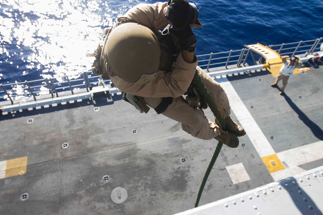 A U.S. Marine fast-ropes out of an SH-60 Seahawk helicopter aboard the amphibious assault ship USS Kearsarge in the North Red Sea, Nov. 5, 2015. U.S. Marine Corps photo by Cpl. Jalen D. Phillips