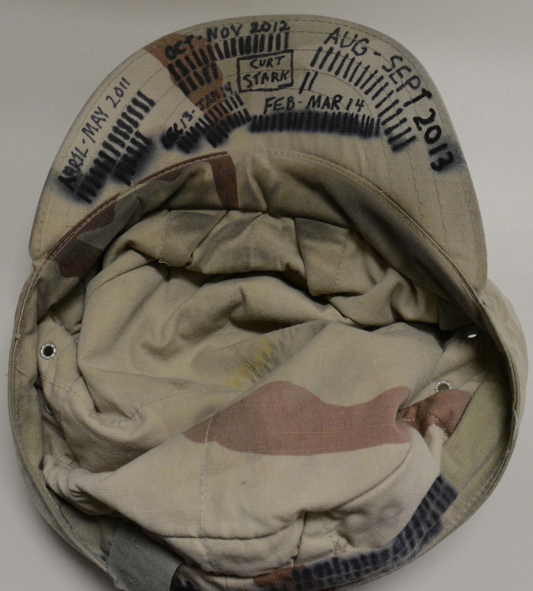 Master Sgt. Curtis Stark's hat is displayed on a desk inside the Wing Operations Center at Al Udeid Air Base, Qatar Nov. 15. Stark is the 7th Expeditionary Air Combat Control Squadron superintendent. He uses hats like the one pictured here to keep track of his many deployments. Stark has deployed 17 times in support of contingency operations and has accumulated more than 4,000 combat flying hours. After nearly 30 years of service he plans to retire from the Air Force in March 2016. (U.S. Air Force photo by Tech. Sgt. James Hodgman/Released)