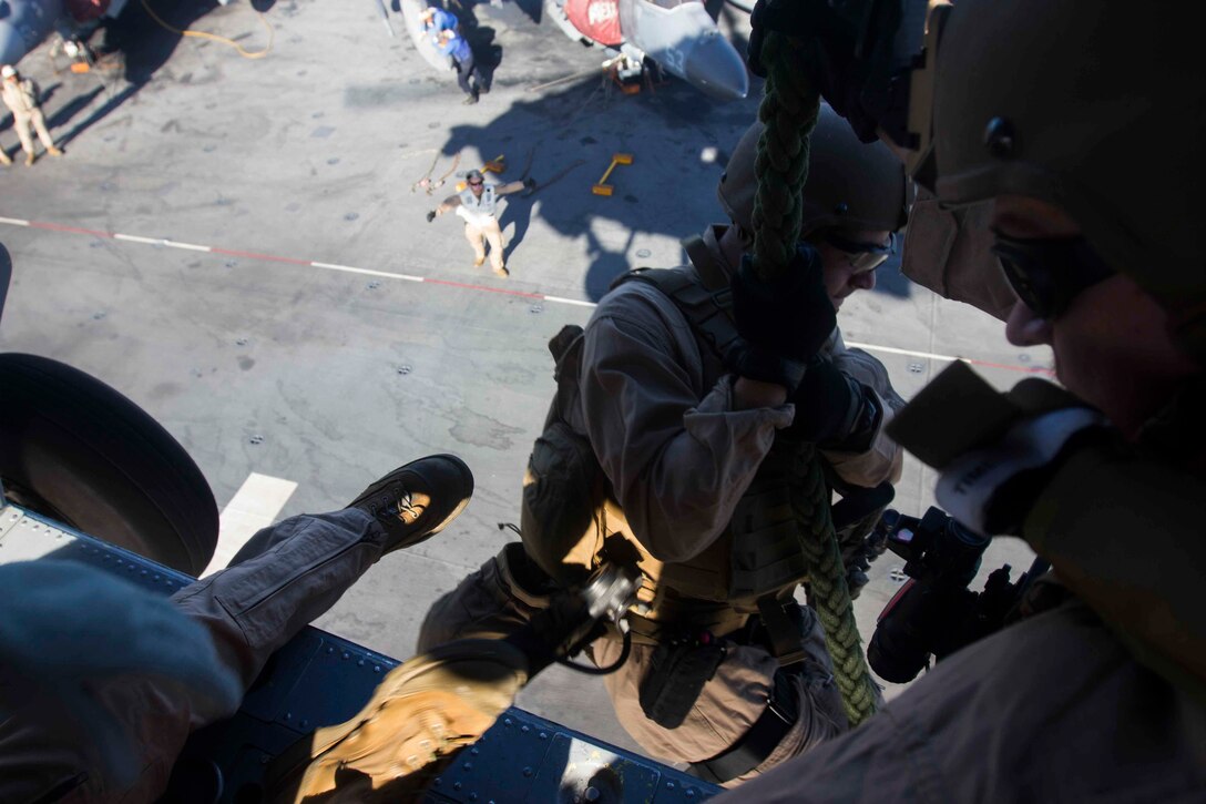 A U.S. Marine fast-ropes out of an SH-60 Seahawk helicopter aboard the amphibious assault ship USS Kearsarge in the North Red Sea, Nov. 5, 2015. U.S. Marine Corps photo by Cpl. Jalen D. Phillips 