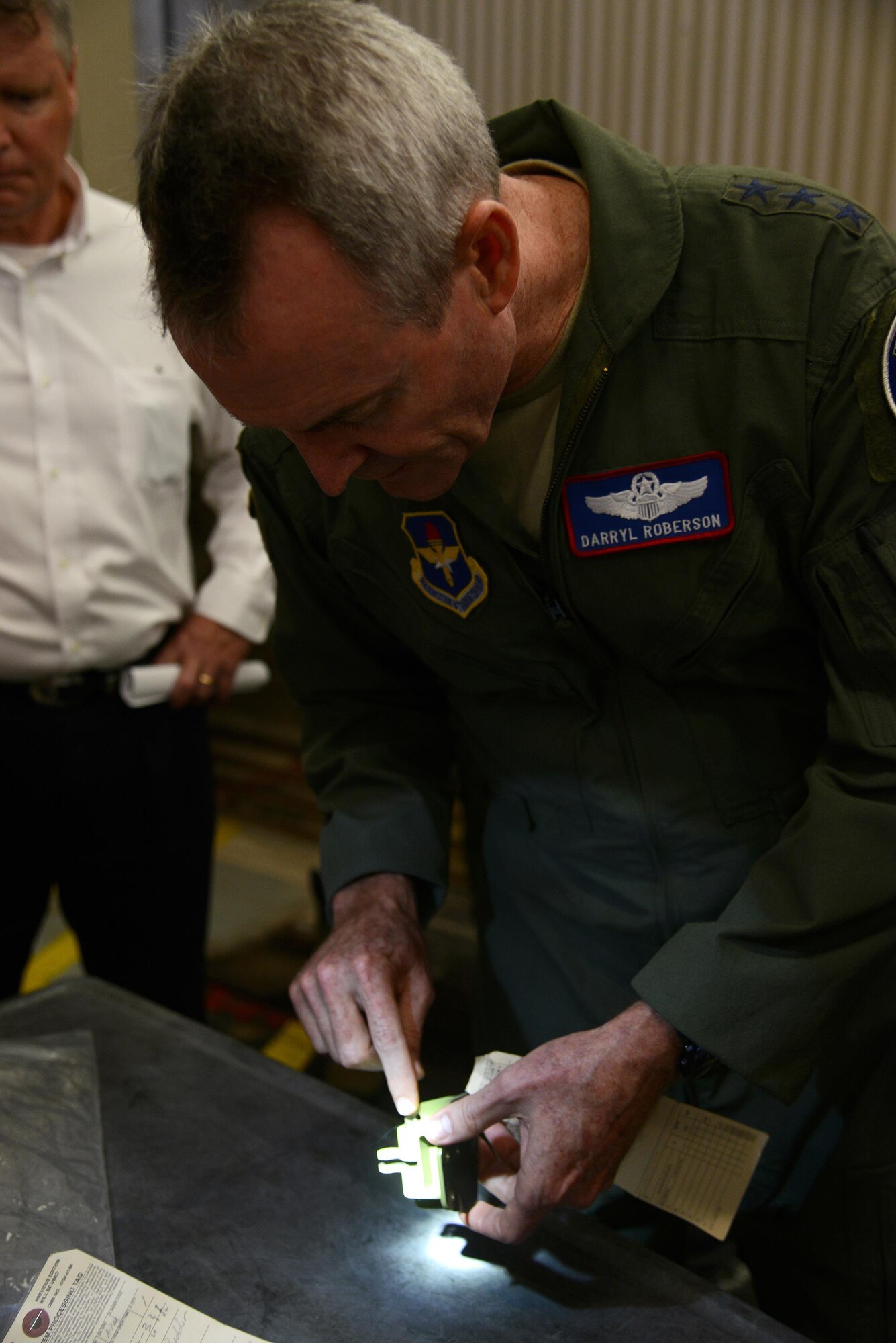 Lt. Gen. Darryl Roberson, commander of Air Education and Training Command, inspects a T-6A Texan II aircraft part during a tour of Laughlin Air Force Base, Texas, Nov. 16, 2015. Roberson visited with Laughlin’s 47th Maintenance Directorate to discuss the maintenance operations of training aircraft. (U.S. Air Force photo by Airman 1st Class Ariel D. Partlow)